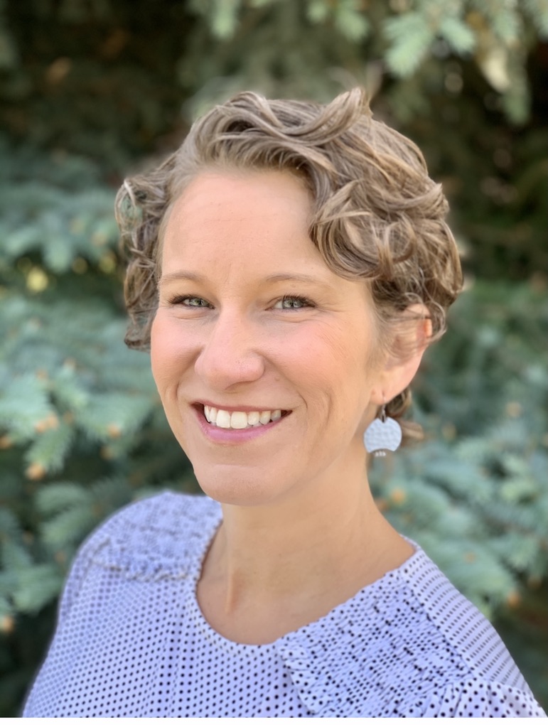 head shot of short light brown hair female, smiling